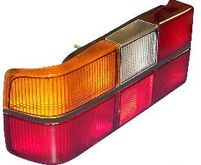 Volvo sedan, 242, 262, 264, 1979-1984 Tail light assembly with six light panels with Black Center Molding, COMPLETE  with circuit board, sockets, bulbs. Left side/Driver side 1307771