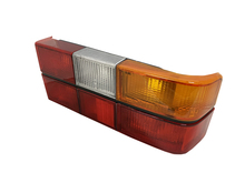 Volvo sedan, 242, 262, 264, 1979-1984 Tail light assembly with six light panels with Black Center Molding, COMPLETE with circuit board, sockets, bulbs. Right side/Passenger side 1307772